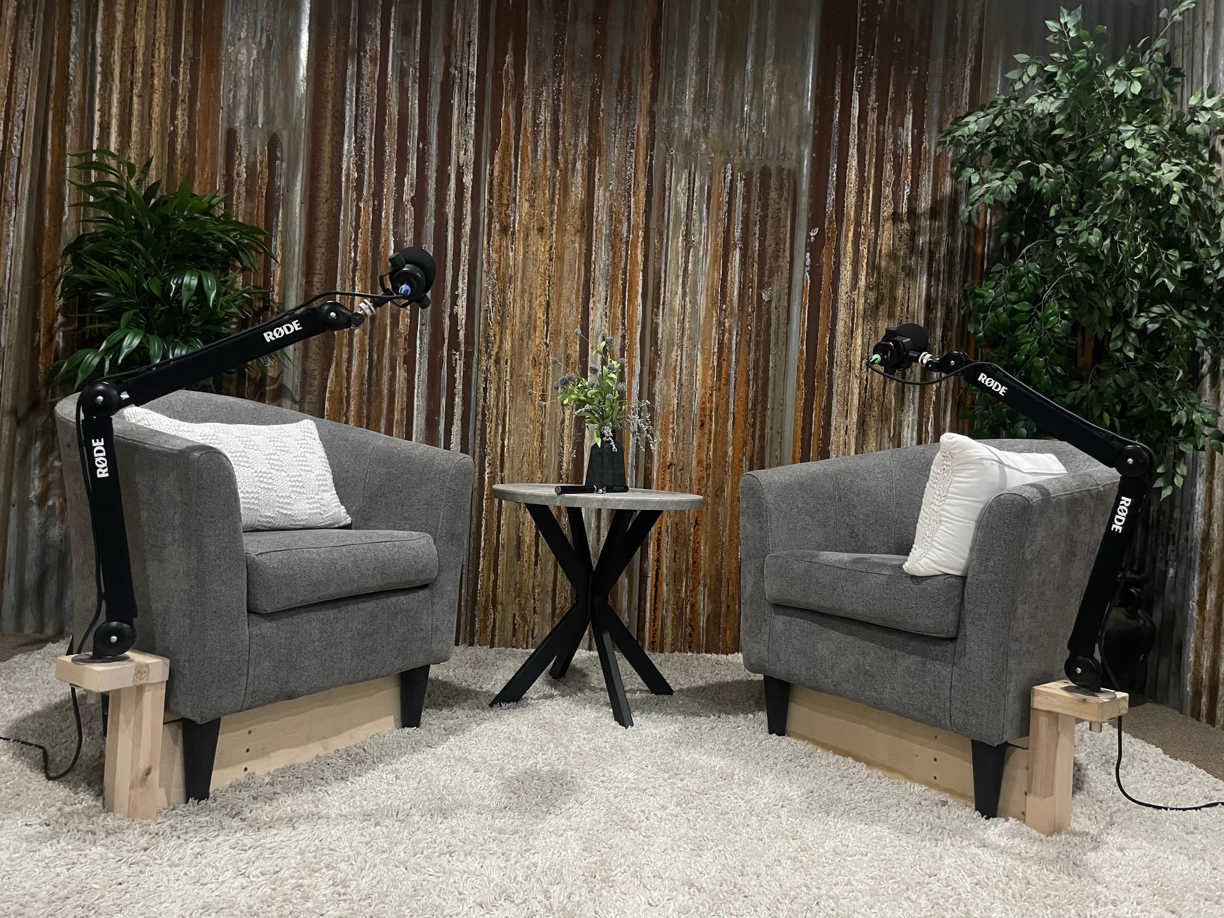 Ranch House Studios podcast set with two chairs, microphones, and rustic backdrop in Bartonville, Texas